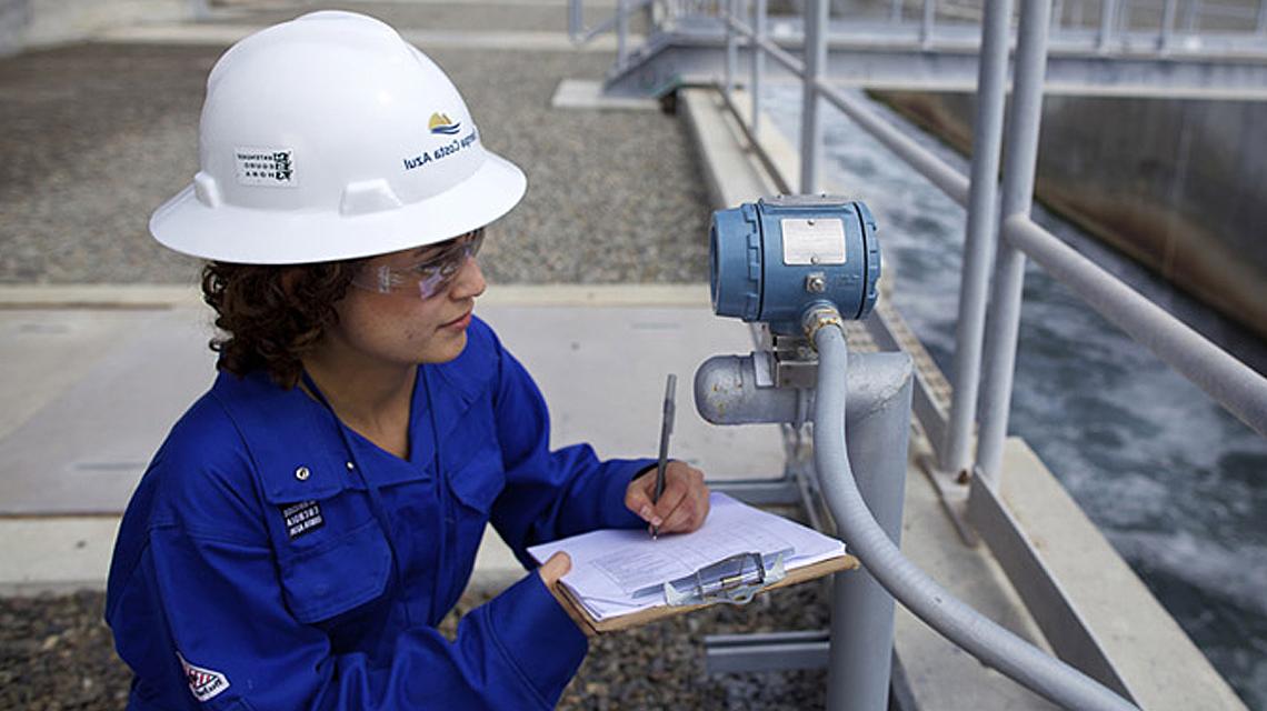 An ECA LNG team member checks equipment