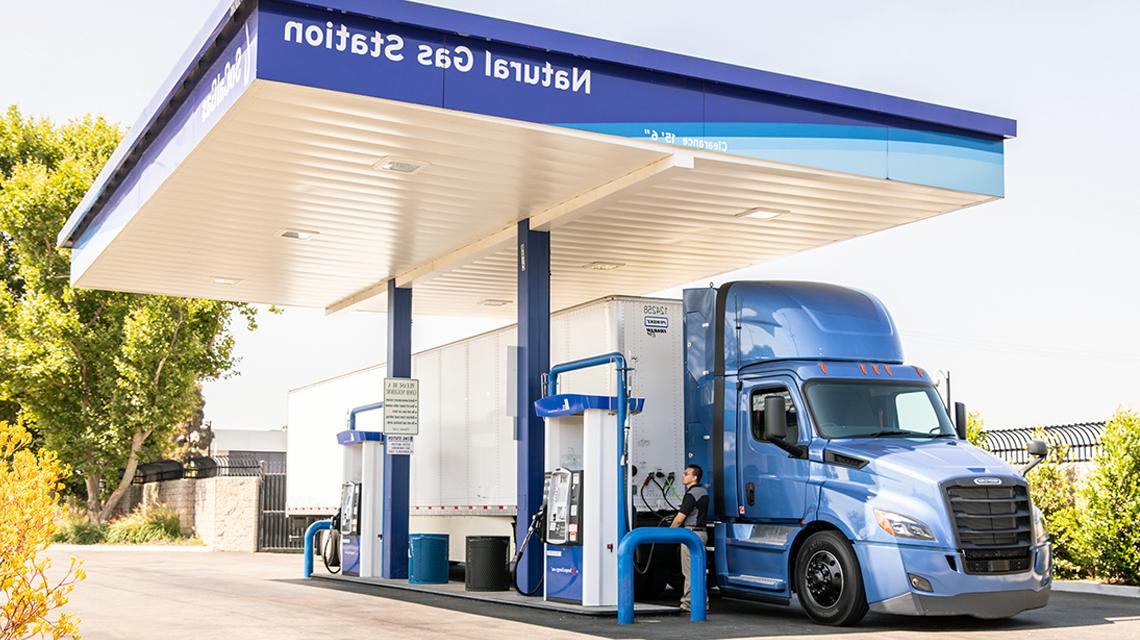 A driver fills the gas tank of a semi truck at one of SoCalGas' natural gas vehicle fueling stations